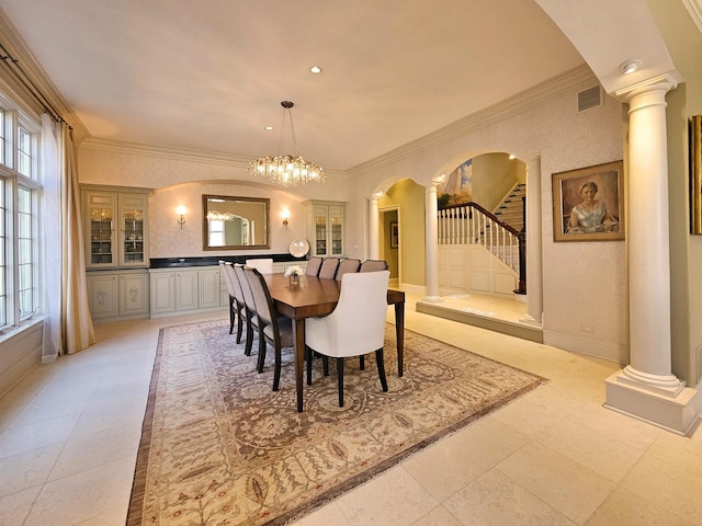 dining room featuring ornate columns, arched walkways, plenty of natural light, crown molding, and recessed lighting
