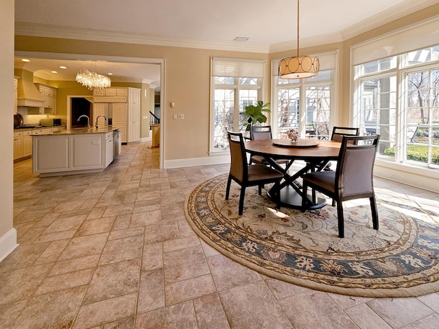 dining space with baseboards, a chandelier, stone tile floors, and crown molding