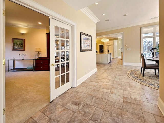 corridor with stone tile floors, baseboards, ornamental molding, a chandelier, and recessed lighting