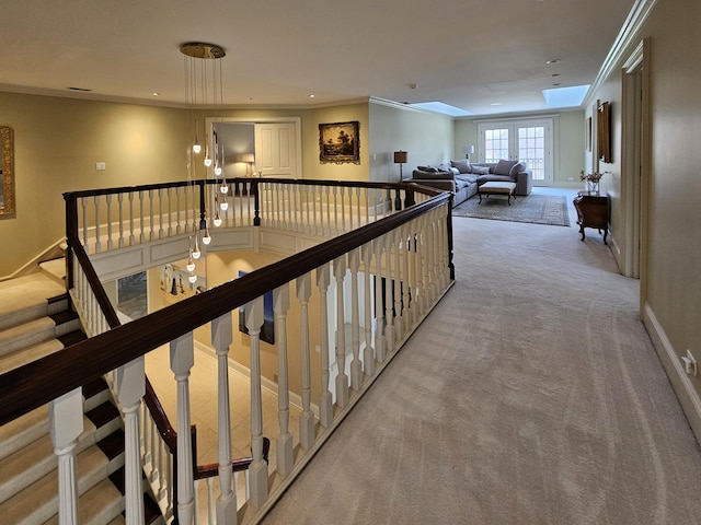 hall with carpet, ornamental molding, an upstairs landing, baseboards, and recessed lighting