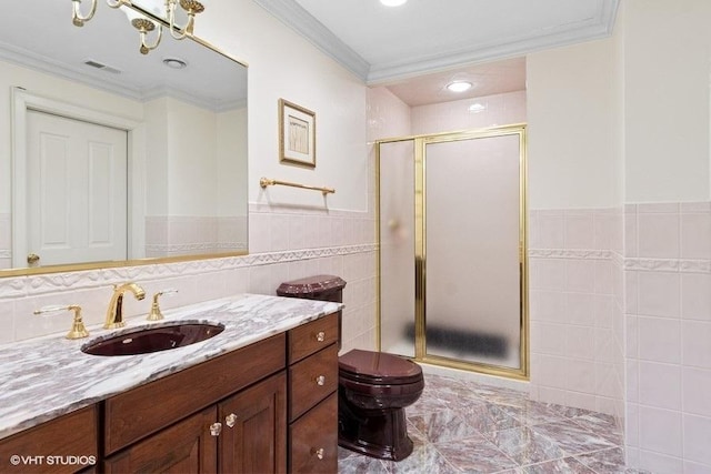 full bathroom with tile walls, a shower stall, crown molding, vanity, and toilet