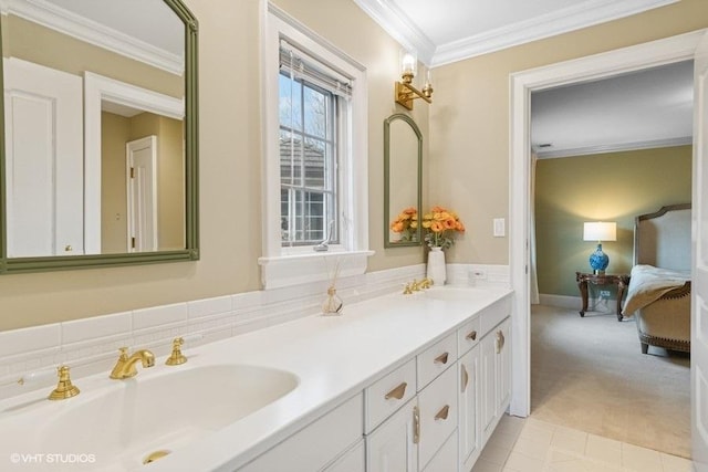 ensuite bathroom with ornamental molding and double vanity