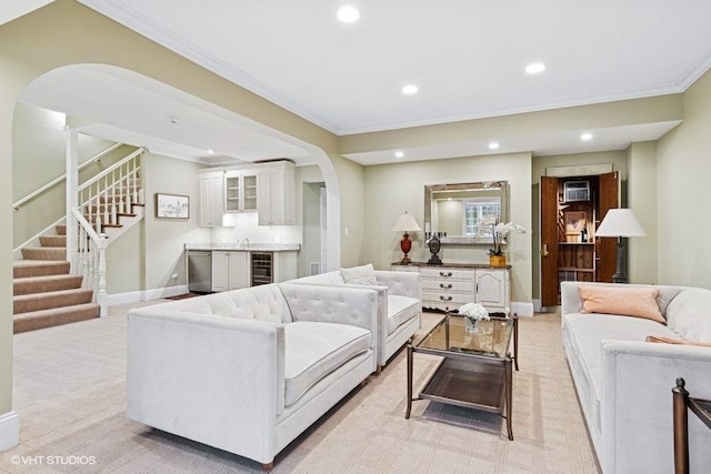 living room with arched walkways, crown molding, stairs, recessed lighting, and baseboards