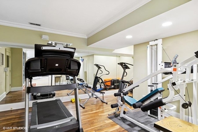 workout room with crown molding, wood finished floors, baseboards, and recessed lighting
