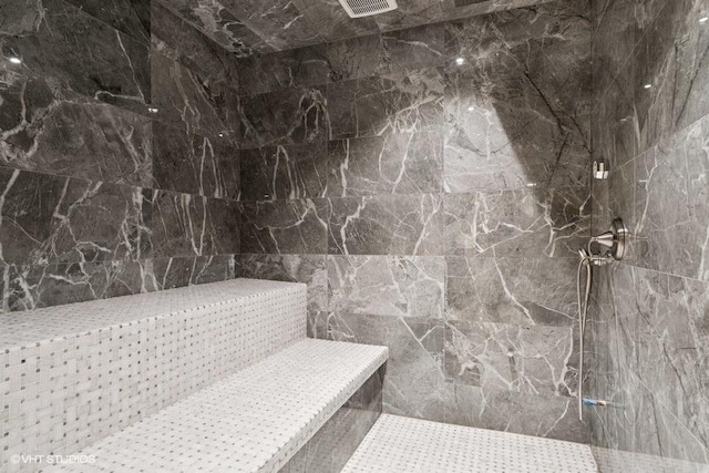 full bath featuring tiled shower