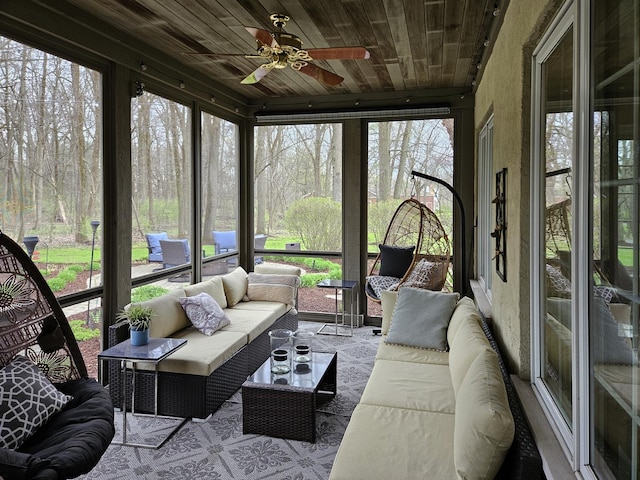 sunroom with an outdoor living space, a ceiling fan, and healthy amount of natural light