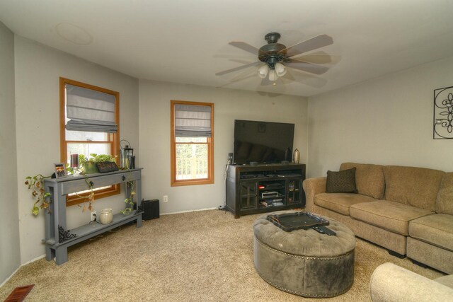 carpeted living area featuring a ceiling fan and visible vents