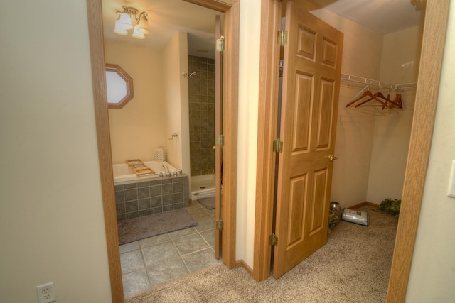 hallway with tile patterned floors and carpet