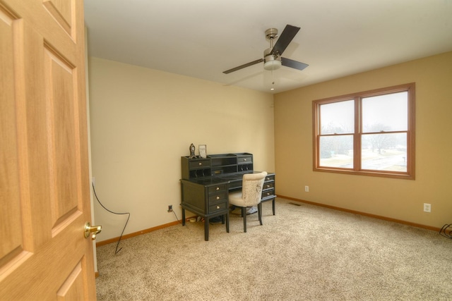 carpeted office featuring visible vents, baseboards, and a ceiling fan