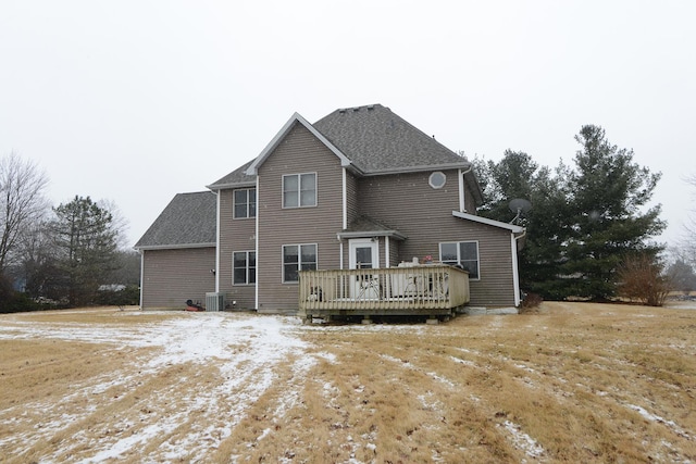 back of house featuring central AC unit, a deck, and roof with shingles