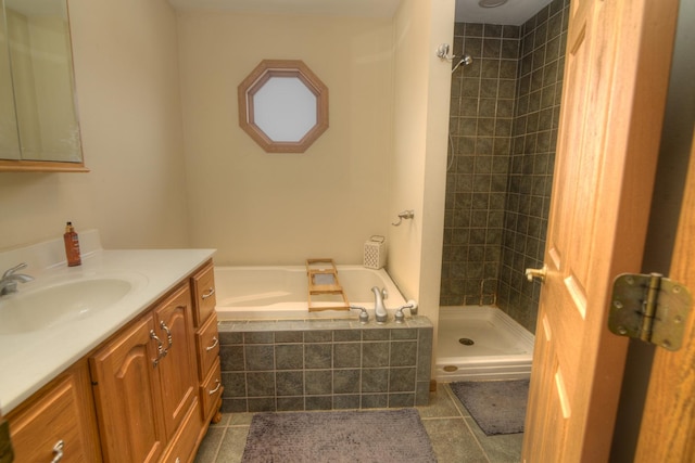 bathroom with tile patterned flooring, a shower stall, vanity, and a garden tub