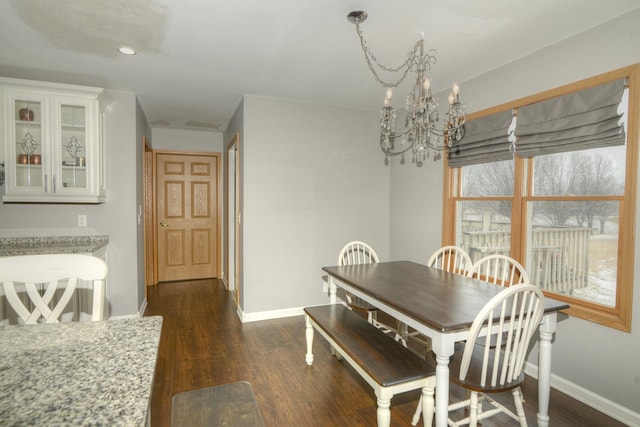 dining space with recessed lighting, baseboards, a notable chandelier, and dark wood-style floors