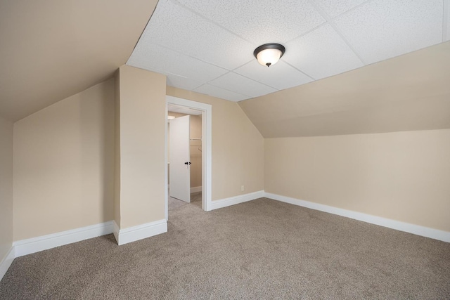 bonus room featuring lofted ceiling, carpet flooring, and baseboards