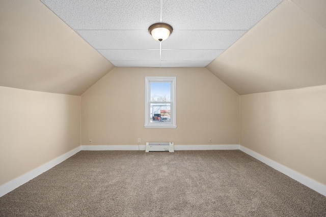 additional living space with carpet floors, lofted ceiling, baseboards, and a baseboard radiator