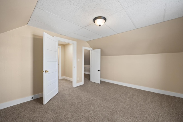 additional living space with vaulted ceiling, carpet, and baseboards