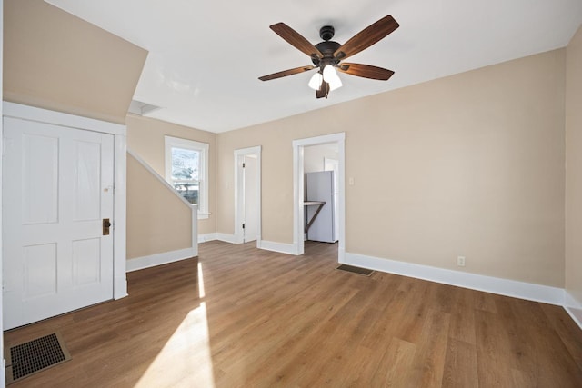 interior space with visible vents, baseboards, and wood finished floors