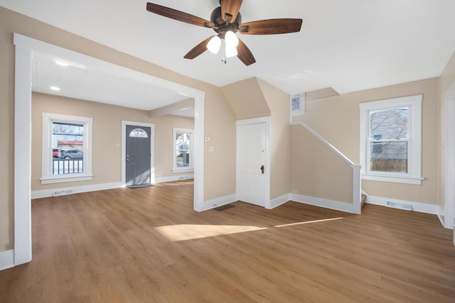 unfurnished living room with visible vents, baseboards, and light wood-style floors