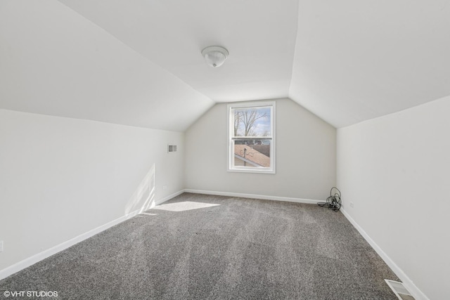 additional living space featuring lofted ceiling, carpet, baseboards, and visible vents