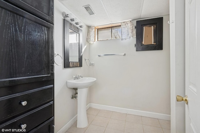 bathroom with tile patterned floors, visible vents, baseboards, and a textured ceiling