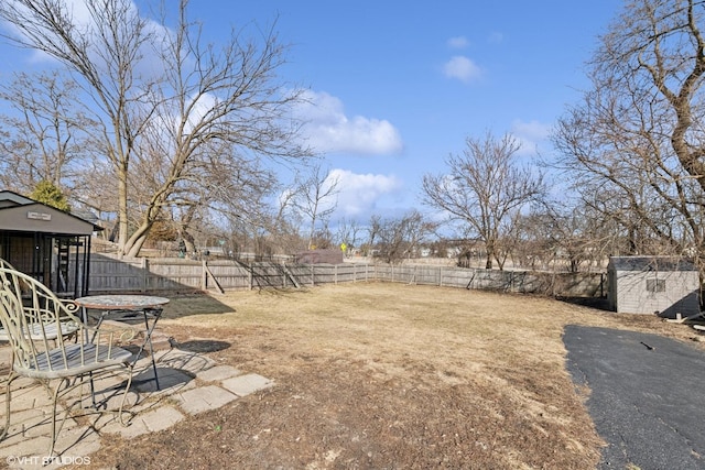 view of yard with a fenced backyard and an outdoor structure