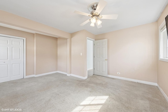 unfurnished bedroom featuring a ceiling fan, baseboards, and carpet floors