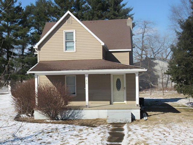 view of front facade featuring a porch and a shingled roof