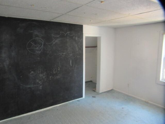 unfurnished bedroom featuring a paneled ceiling