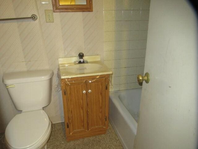 bathroom with a washtub, a shower, vanity, and toilet