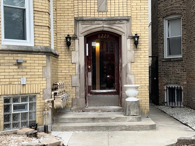 doorway to property with brick siding