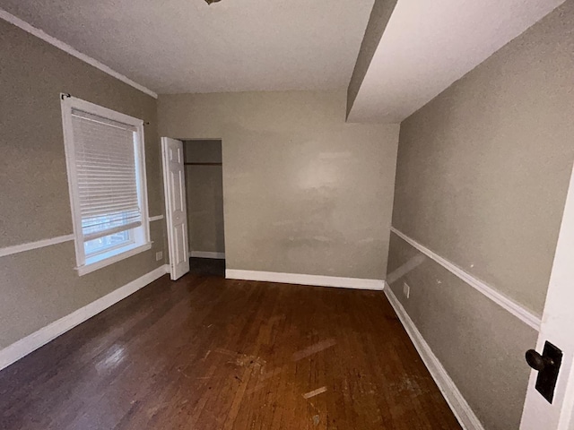 unfurnished room featuring baseboards and wood finished floors