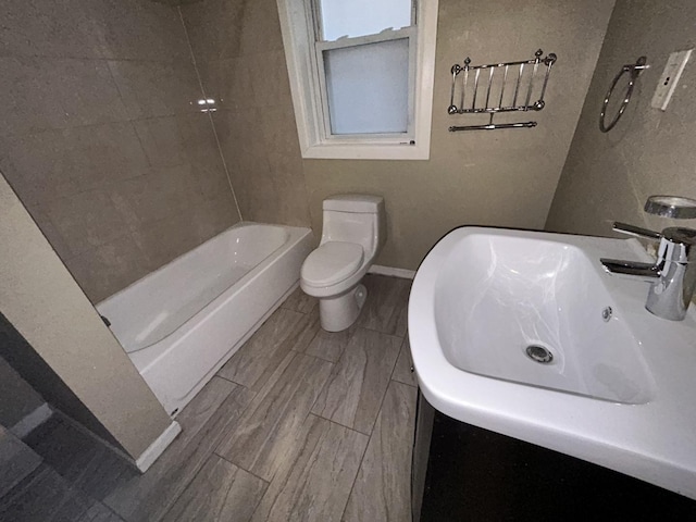 full bath featuring baseboards, a sink, and toilet