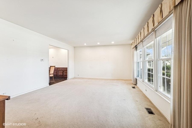 unfurnished room featuring recessed lighting, visible vents, light carpet, and baseboards