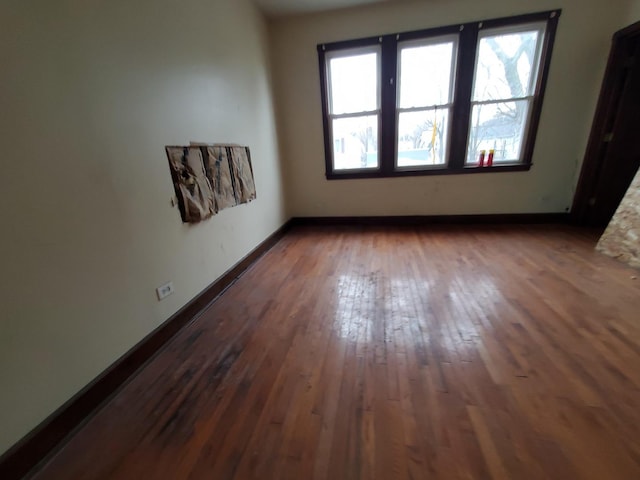 unfurnished room featuring dark wood finished floors and baseboards