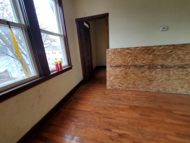 hall featuring baseboards and wood finished floors