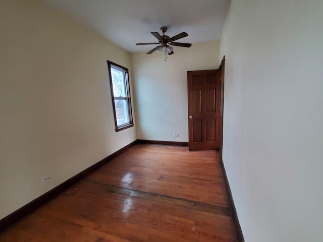 spare room with a ceiling fan, baseboards, and wood finished floors