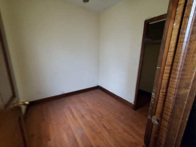 unfurnished bedroom featuring baseboards and wood finished floors