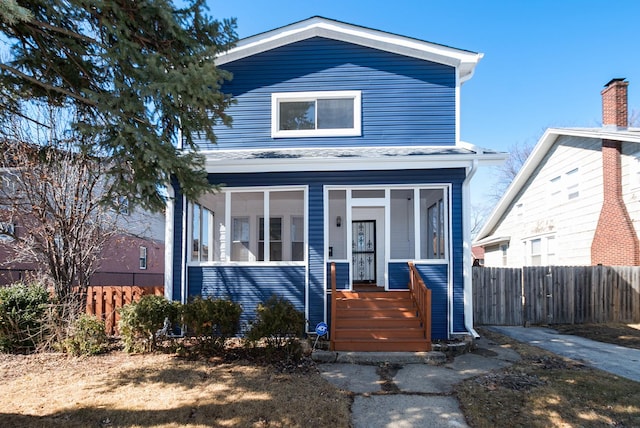 view of front of home featuring fence