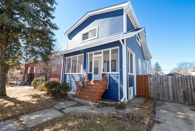 view of front of home featuring covered porch, fence, and a gate