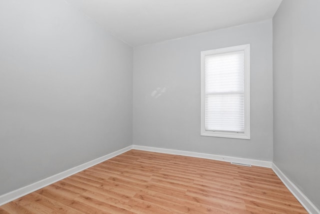 empty room featuring light wood-style floors and baseboards