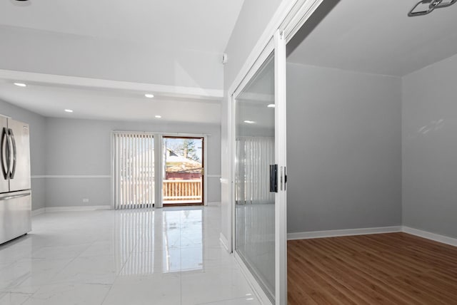 empty room with recessed lighting, marble finish floor, and baseboards