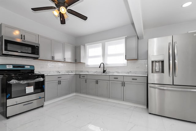 kitchen with marble finish floor, stainless steel appliances, gray cabinets, and light countertops