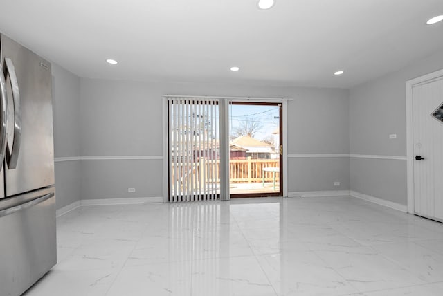 empty room featuring marble finish floor, baseboards, and recessed lighting