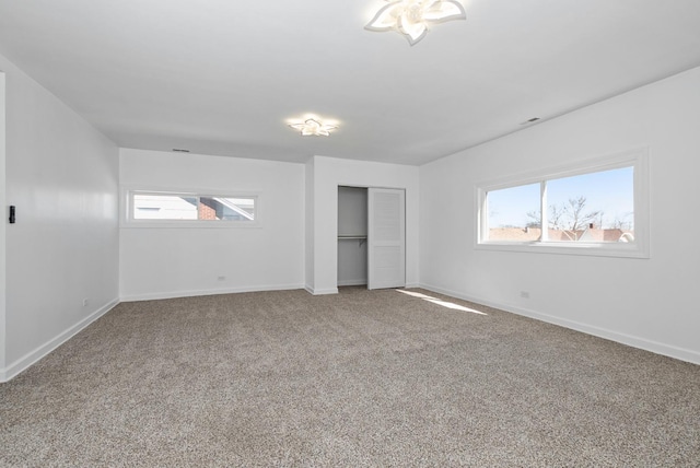 unfurnished bedroom with a closet, carpet flooring, and baseboards