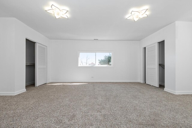 unfurnished bedroom with carpet and baseboards