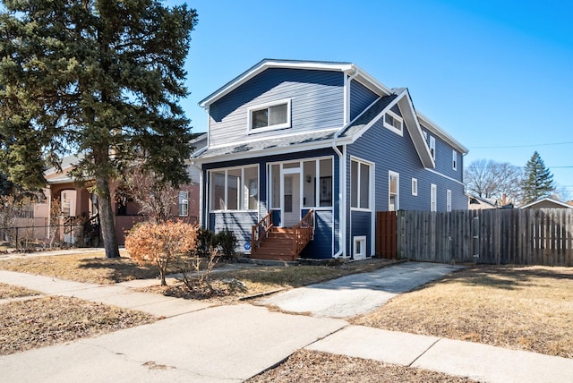 view of front of home featuring fence