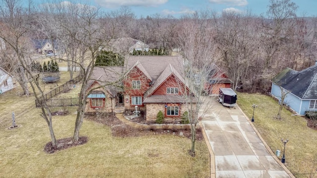 view of front of home with driveway and a front lawn