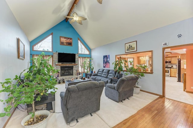 living area with a fireplace with raised hearth, ceiling fan, high vaulted ceiling, baseboards, and wood-type flooring