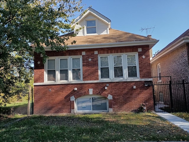 exterior space with brick siding, fence, and a lawn