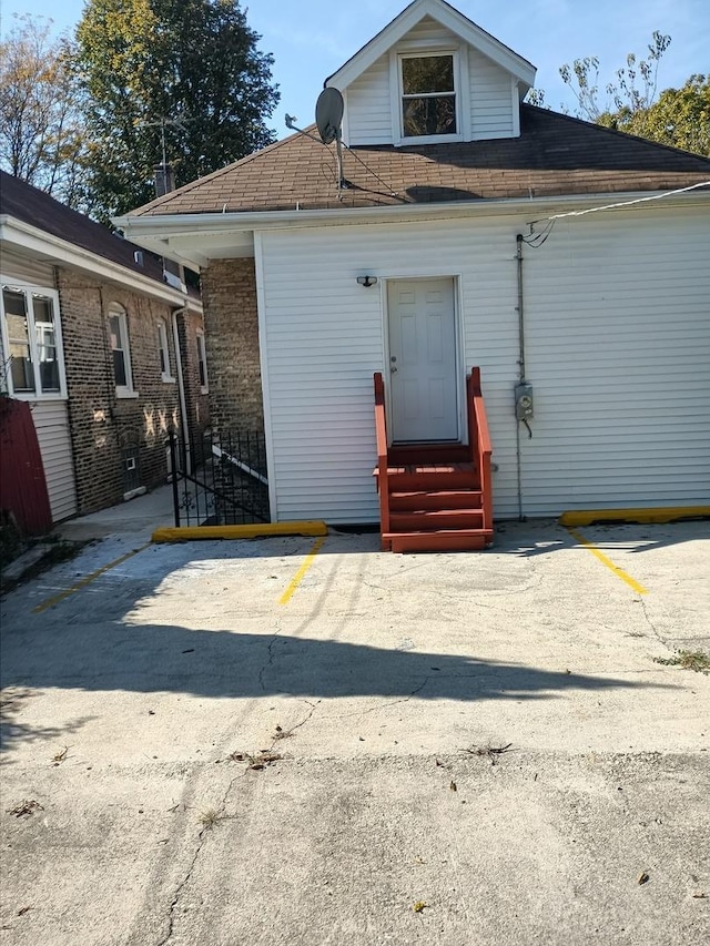 rear view of house featuring entry steps