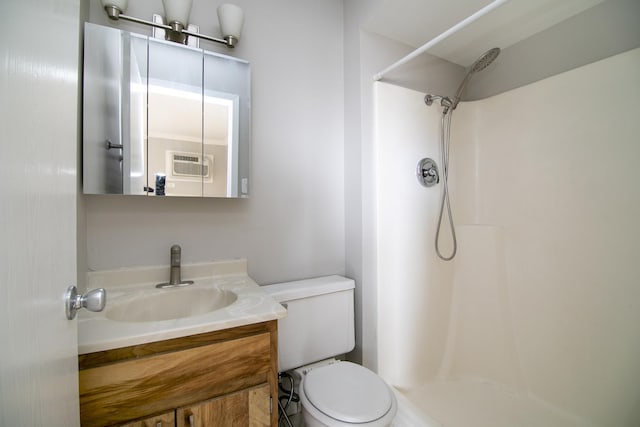 bathroom featuring a shower, toilet, vanity, and a wall unit AC